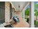 Relaxing front porch with rocking chairs, brick floor, and ceiling fans at 487 Carmichael Cir, Canton, GA 30115