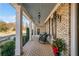 Inviting covered front porch with brick flooring and rocking chairs at 487 Carmichael Cir, Canton, GA 30115