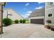 Garage and driveway with basketball hoop surrounded by manicured landscaping at 487 Carmichael Cir, Canton, GA 30115