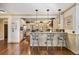 Open-concept kitchen with granite countertops, stainless steel appliances, and bar seating flows seamlessly at 487 Carmichael Cir, Canton, GA 30115
