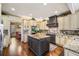 Open kitchen with granite counters, stainless appliances, kitchen island, and custom cabinets offers space at 487 Carmichael Cir, Canton, GA 30115