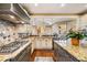 Gourmet kitchen boasts granite countertops, stainless steel appliances, and custom cabinets for a chef's delight at 487 Carmichael Cir, Canton, GA 30115