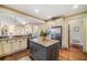 Kitchen with granite island, stainless refrigerator, and custom cabinets is ideal for entertaining and cooking at 487 Carmichael Cir, Canton, GA 30115