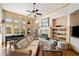 Bright living room with a grand piano, fireplace, built-in shelves and large windows for natural light at 487 Carmichael Cir, Canton, GA 30115