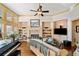 Cozy living room featuring a fireplace, built-in shelving, hardwood floors, and comfortable seating at 487 Carmichael Cir, Canton, GA 30115