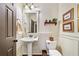 Charming powder room featuring a pedestal sink, wainscoting, and stylish decor at 487 Carmichael Cir, Canton, GA 30115