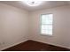 Small bedroom with a window and hardwood floors at 5624 Stonington Trace Pkwy, Stone Mountain, GA 30087
