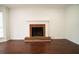 Living room featuring a cozy brick fireplace and hardwood flooring at 5624 Stonington Trace Pkwy, Stone Mountain, GA 30087