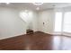 Hardwood floors and modern lighting create an inviting living space with stairs, and a large bay window at 5624 Stonington Trace Pkwy, Stone Mountain, GA 30087