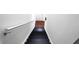 Interior shot of a stairway featuring dark-painted stairs and a white handrail against a white wall at 5624 Stonington Trace Pkwy, Stone Mountain, GA 30087