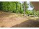 View of sloping backyard leading to a wooded area at 2509 Browns Mill Se Rd, Atlanta, GA 30354