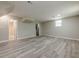 Unfinished basement with updated flooring, recessed lighting, and access to a utility area at 2509 Browns Mill Se Rd, Atlanta, GA 30354