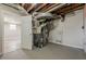 Basement utility area with open ceiling and view to finished area at 2509 Browns Mill Se Rd, Atlanta, GA 30354