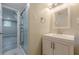 Bathroom with updated vanity, framed mirror, and glass enclosed shower at 2509 Browns Mill Se Rd, Atlanta, GA 30354