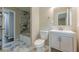 Updated bathroom with marble floors, modern vanity, and tiled shower/tub at 2509 Browns Mill Se Rd, Atlanta, GA 30354
