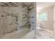 Renovated bathroom with marble-tiled shower/tub and modern fixtures at 2509 Browns Mill Se Rd, Atlanta, GA 30354