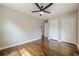 Empty bedroom features hardwood floors, a ceiling fan, and double-door closets at 2509 Browns Mill Se Rd, Atlanta, GA 30354