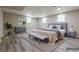 Staged primary bedroom featuring wood-look flooring and a comfortable sitting area at 2509 Browns Mill Se Rd, Atlanta, GA 30354