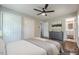 Staged bedroom featuring hardwood floors, ceiling fan, and closet space, with an attached bathroom at 2509 Browns Mill Se Rd, Atlanta, GA 30354