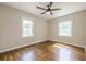 Empty bedroom features hardwood floors, a ceiling fan, and lots of natural light at 2509 Browns Mill Se Rd, Atlanta, GA 30354