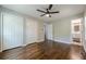 Bright bedroom with hardwood floors, ceiling fan, and double door closets at 2509 Browns Mill Se Rd, Atlanta, GA 30354