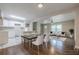 Open concept dining area with hardwood floors, a ceiling fan, and an adjacent modern kitchen at 2509 Browns Mill Se Rd, Atlanta, GA 30354
