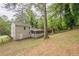 Back exterior view of home with a screened in porch and wooded yard at 2509 Browns Mill Se Rd, Atlanta, GA 30354