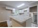 Renovated kitchen with white cabinets, marble countertops, and stainless steel sink beneath a bright window at 2509 Browns Mill Se Rd, Atlanta, GA 30354