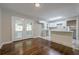 Hardwood floors in kitchen and breakfast nook featuring a serving bar with marble top and white cabinets at 2509 Browns Mill Se Rd, Atlanta, GA 30354