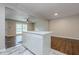 Bright kitchen featuring a white island with marble countertop and hardwood floors leading to the dining room at 2509 Browns Mill Se Rd, Atlanta, GA 30354