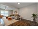 Comfortable living room with hardwood floors, a ceiling fan, and a stylish grey sofa at 2509 Browns Mill Se Rd, Atlanta, GA 30354