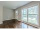Bright living room featuring hardwood floors, a large window, and a crisp, clean aesthetic at 2509 Browns Mill Se Rd, Atlanta, GA 30354