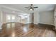 Open-concept living area with hardwood floors, a ceiling fan, and a seamless flow to the kitchen at 2509 Browns Mill Se Rd, Atlanta, GA 30354