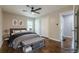 Relaxing main bedroom with hardwood floors, ceiling fan, and ample closet space, virtually staged at 2509 Browns Mill Se Rd, Atlanta, GA 30354