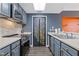 Updated kitchen with stainless appliances, tiled backsplash, and modern lighting at 3481 Lakeside #901 Ne Dr, Atlanta, GA 30326