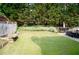 Expansive backyard featuring a well-maintained lawn, mature trees, and patio area for outdoor enjoyment at 3606 Packhorse Run, Marietta, GA 30066