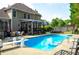 Spacious backyard with a sparkling pool, covered patio, and ample seating perfect for outdoor entertaining and relaxation at 3606 Packhorse Run, Marietta, GA 30066