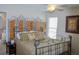 Bedroom featuring wrought iron style bed, decorative pillows, and serene decor creating a tranquil space at 3606 Packhorse Run, Marietta, GA 30066