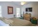 Bedroom featuring TV, neutral colored bedding, dresser, and serene decor creating a tranquil space at 3606 Packhorse Run, Marietta, GA 30066