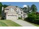 Charming two-story home with a well-manicured lawn, a two-car garage, and lush landscaping at 3606 Packhorse Run, Marietta, GA 30066
