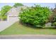 Charming home showcasing a two-car garage, manicured lawn, and a lush, green tree in the front yard at 3606 Packhorse Run, Marietta, GA 30066