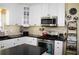 Well-lit kitchen featuring white cabinets, stainless steel appliances, and decorative backsplash at 3606 Packhorse Run, Marietta, GA 30066