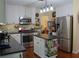 Kitchen featuring white cabinets, stainless steel appliances, island and hardwood floors at 3606 Packhorse Run, Marietta, GA 30066
