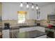 Updated kitchen with stainless steel appliances, white cabinetry, and modern pendant lighting at 3606 Packhorse Run, Marietta, GA 30066