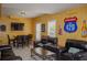 Spacious living room featuring dark leather furniture, a TV, and beer-themed decor at 3606 Packhorse Run, Marietta, GA 30066