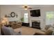 Inviting living room with a fireplace, plush seating, and ample natural light from large windows at 3606 Packhorse Run, Marietta, GA 30066