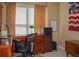 Functional home office with a wooden desk, filing cabinets, and natural light from a large window at 3606 Packhorse Run, Marietta, GA 30066