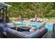 Inviting pool area with cozy seating, a fire pit, and surrounding greenery for a serene outdoor experience at 3606 Packhorse Run, Marietta, GA 30066