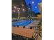 Enchanting poolside ambiance with ambient lighting, lush greenery, and a spacious area for outdoor gatherings and relaxation at 3606 Packhorse Run, Marietta, GA 30066