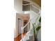 Bright staircase featuring white railings, hardwood floors, and a glimpse of the home's interior at 3606 Packhorse Run, Marietta, GA 30066
